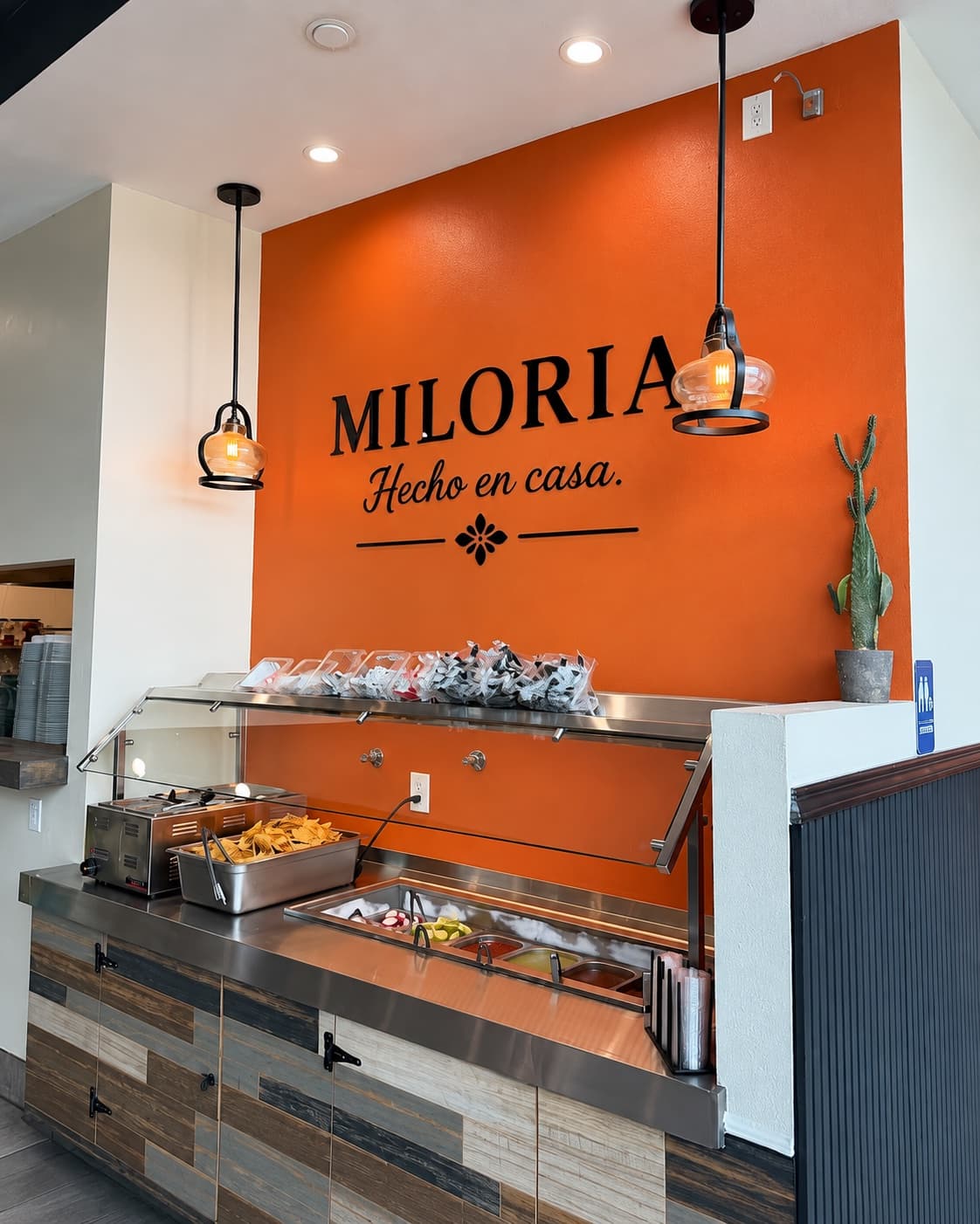 The orange Miloria wall and salsa bar inside the Colton restaurant.